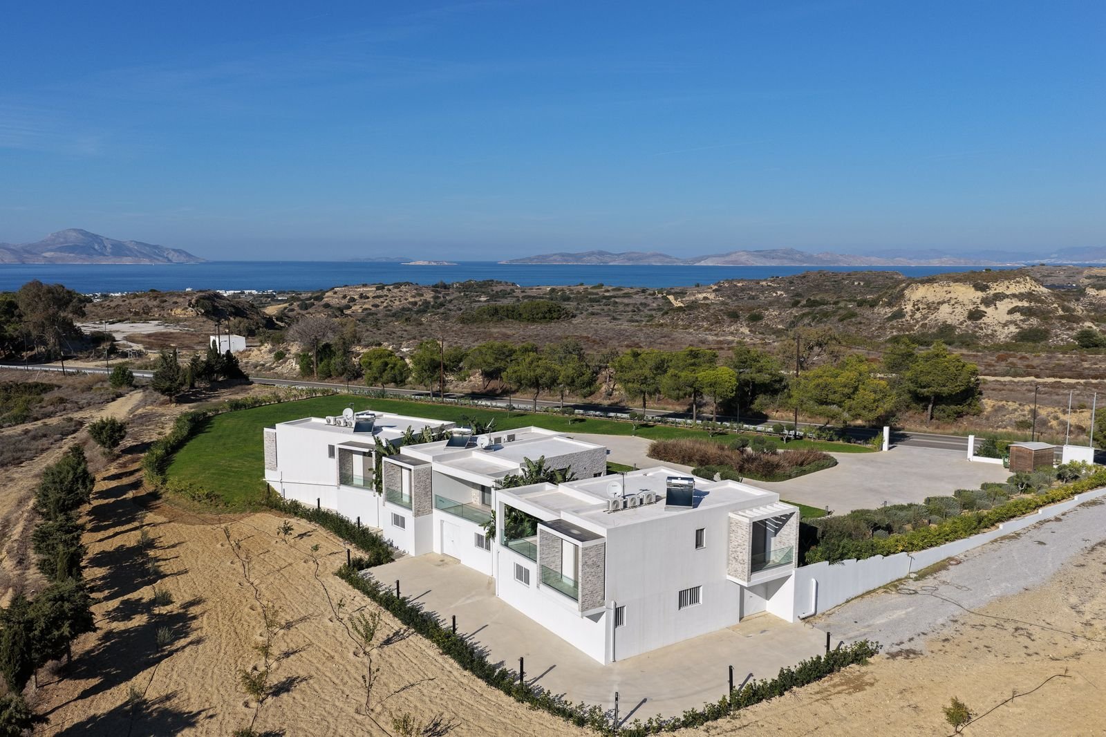 The villas on their hillside with the Aegean and the islands beyond